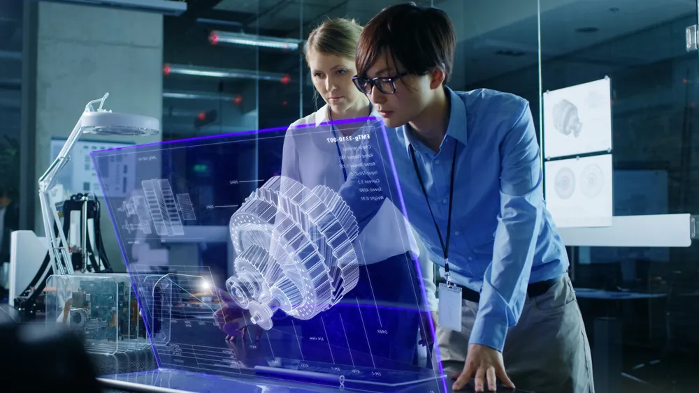 Two engineers reviewing a holographic engine model
